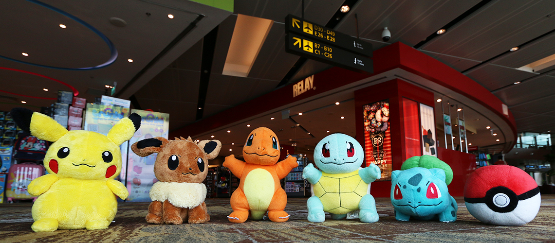 Six pokemon plush toys lined up in a row at Changi Airport